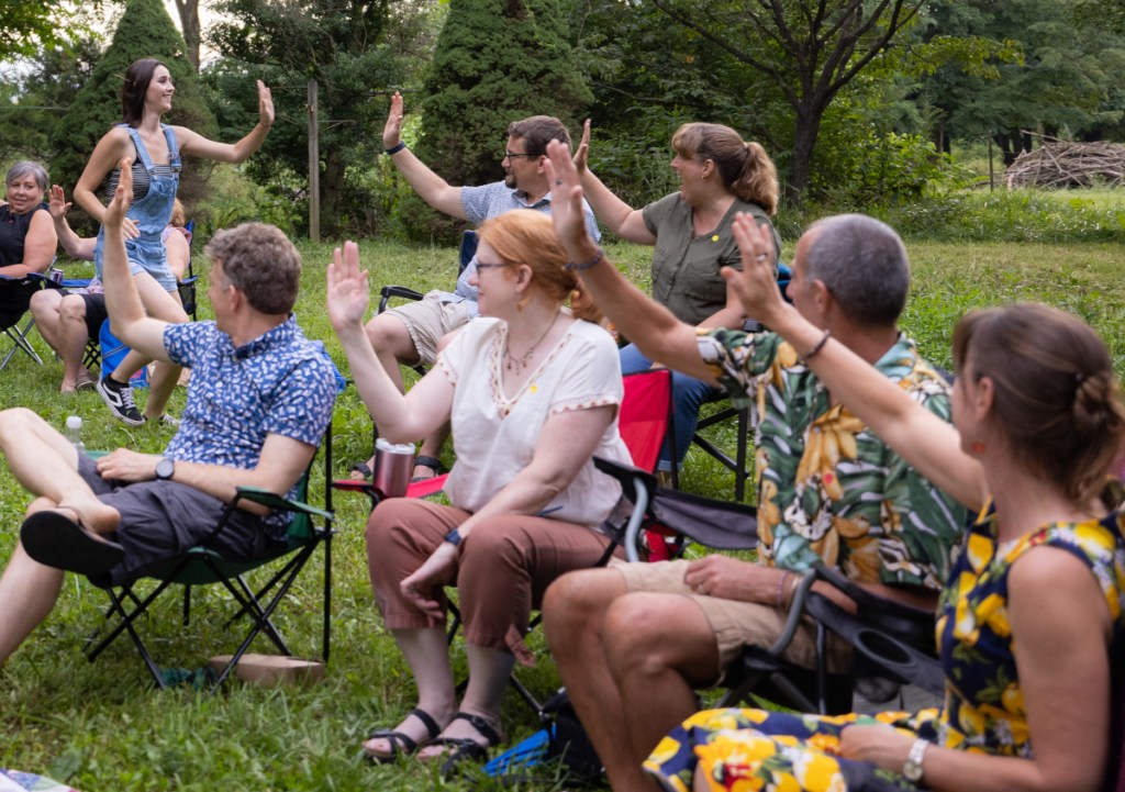Katie runs through the crowd, high-fiving everyone.