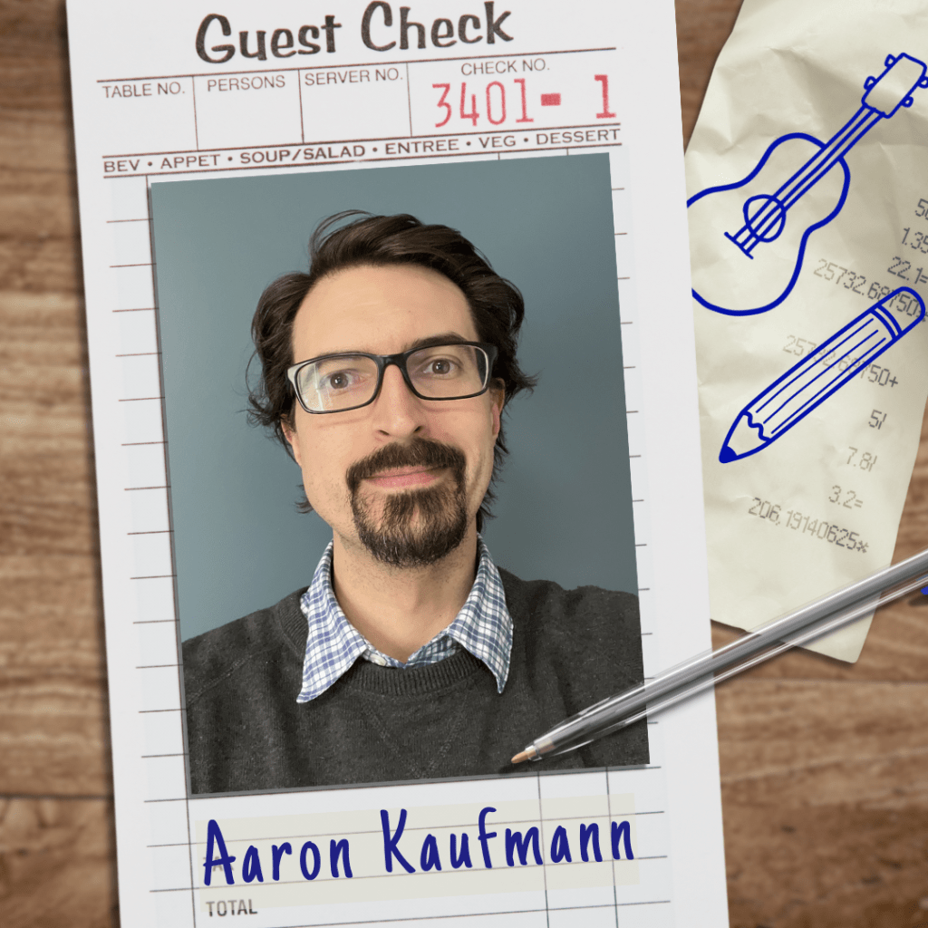 A restaurant guest check on a table, with a guitar and a pencil drawn on it. On top of the check is Aaron Kaufmann's headshot. Aaron is a white man with short, curly, dark brown hair. He has a mustache and beard.  He is wearing a brown sweater over a blue gingham shirt.